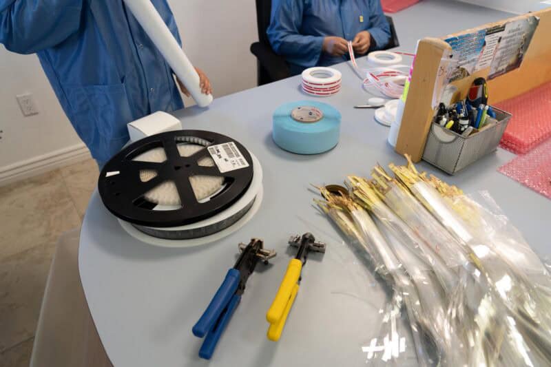 Workers packing Leader Tape Extenders for SMT and SMD reel feeding and splicing