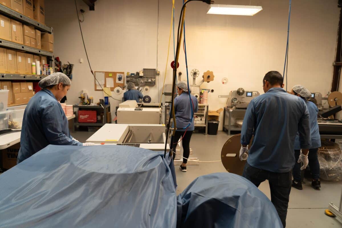 Workers on Smt Production Line Handling Leader Tape Extenders and Smd Components