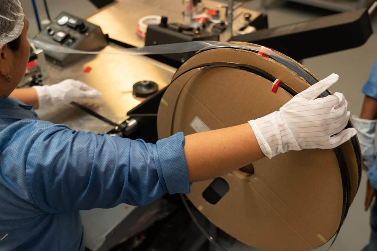 Workers on Smt Production Line Handling Leader Tape Extenders and Smd Components