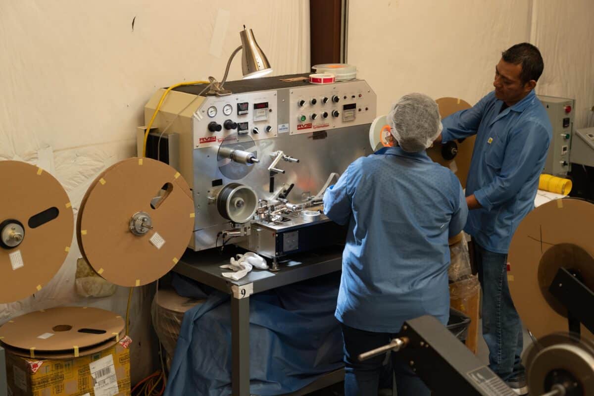Workers on Smt Production Line Handling Leader Tape Extenders and Smd Components