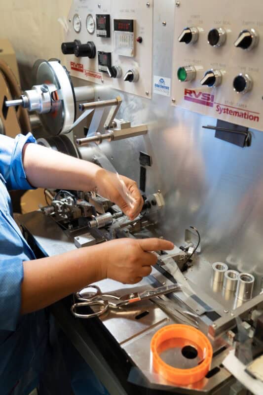 Workers on SMT production line handling Leader Tape Extenders and SMD components