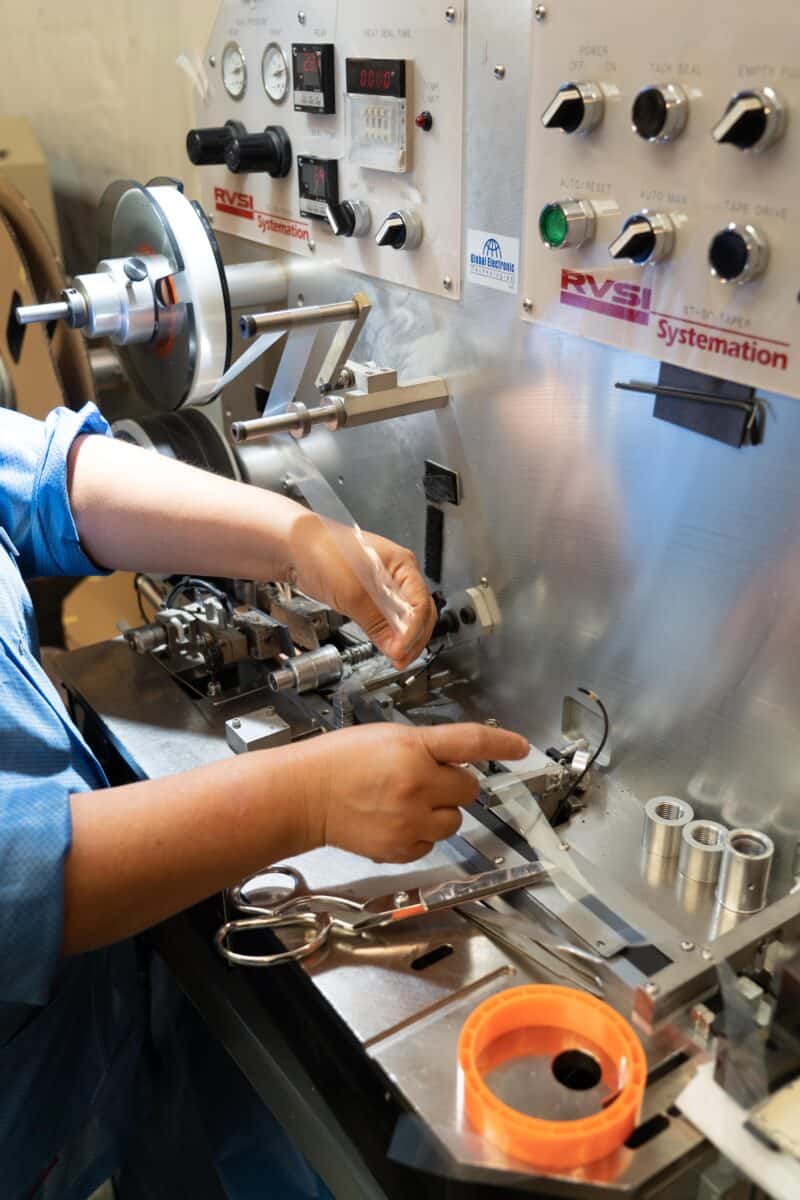 Workers on Smt Production Line Handling Leader Tape Extenders and Smd Components