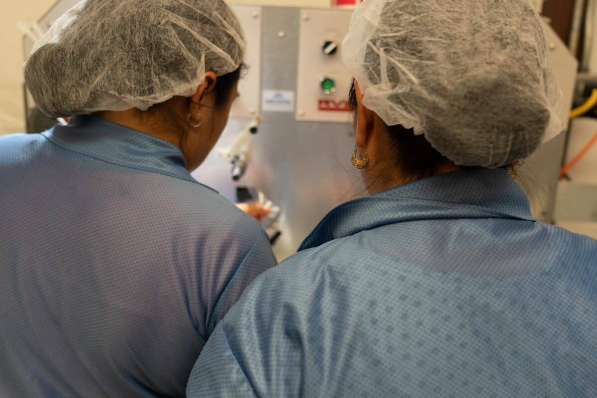 Workers on Smt Production Line Handling Leader Tape Extenders and Smd Components