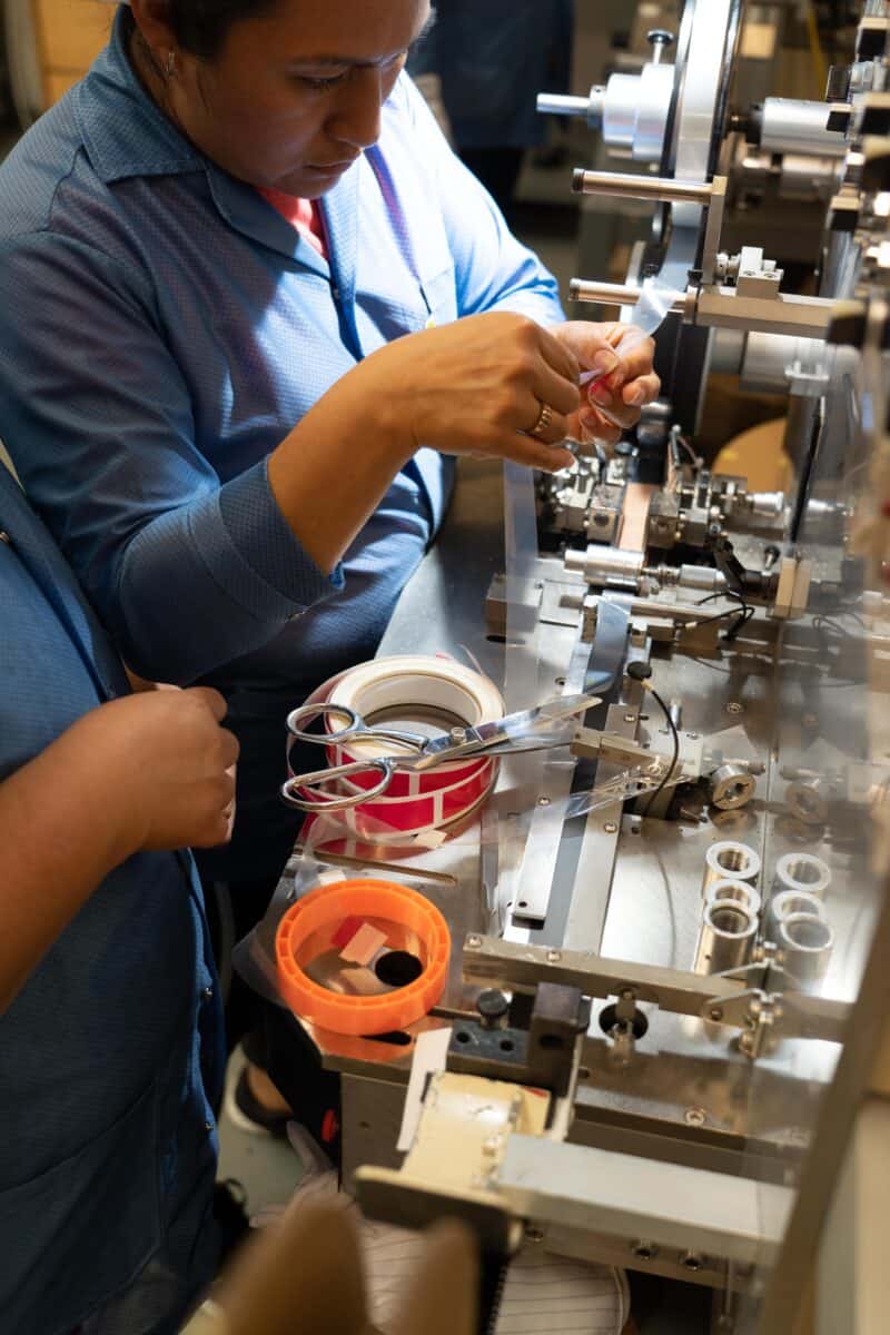 Workers on Smt Production Line Handling Leader Tape Extenders and Smd Components